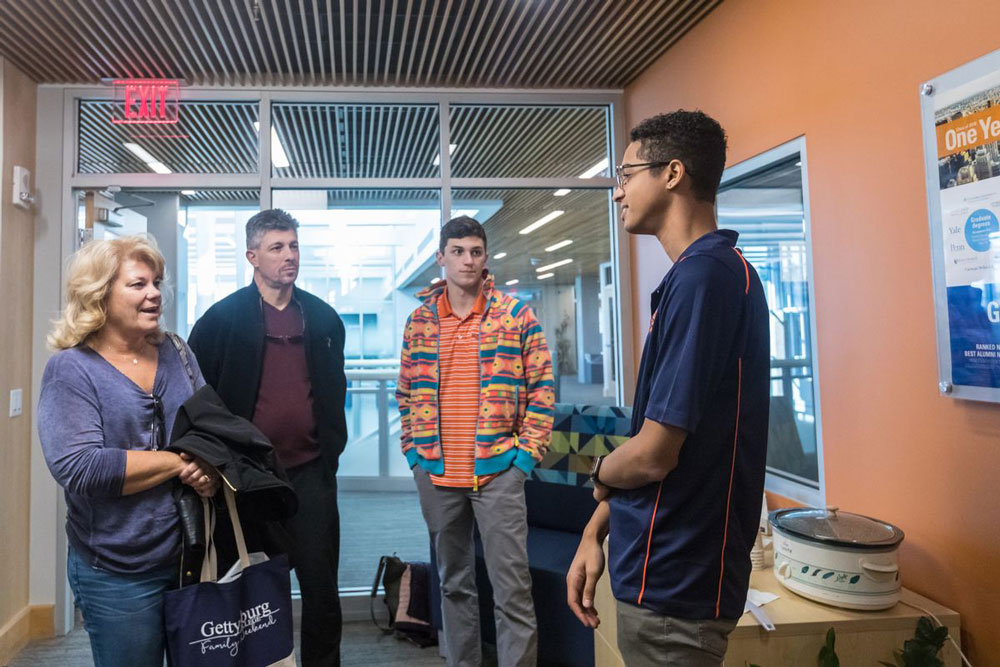 Student speaking with family inside the Center for Career Engagement