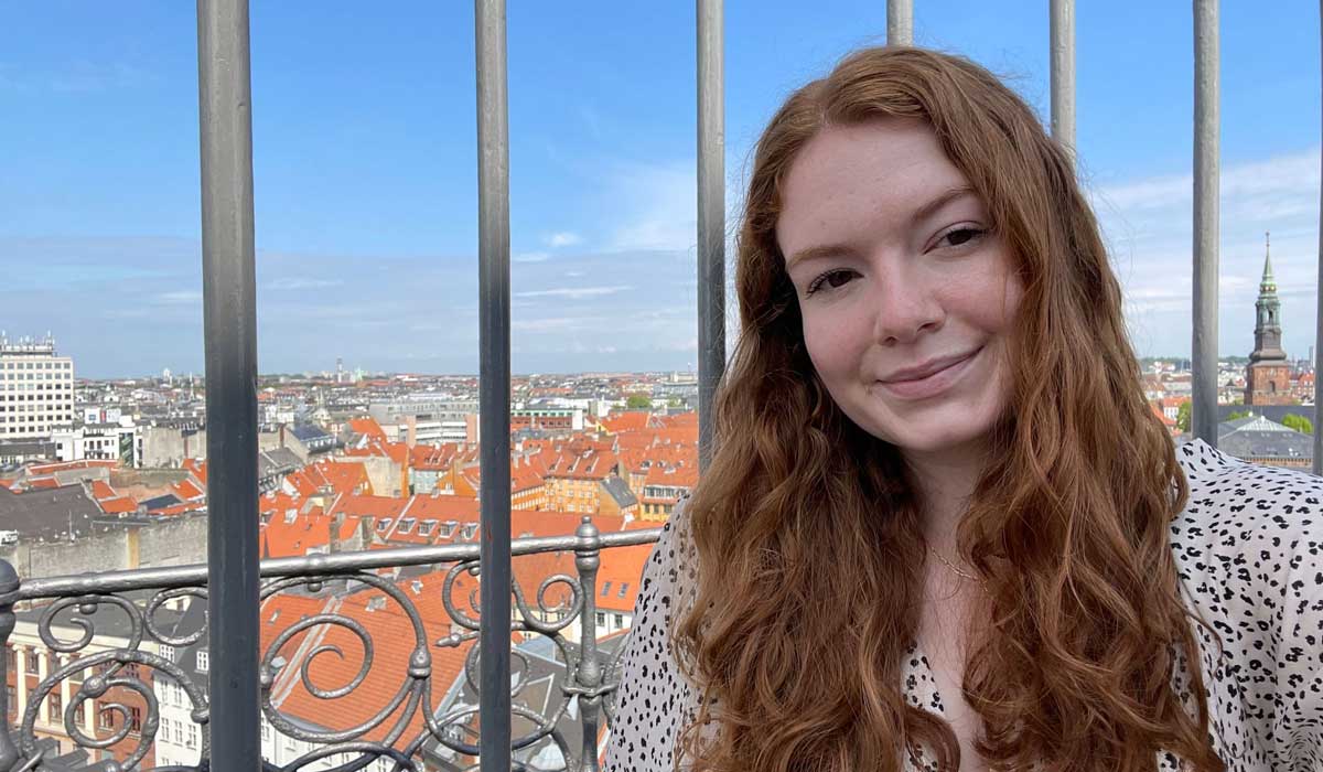 Amandas Oross in front of a town in Denmark