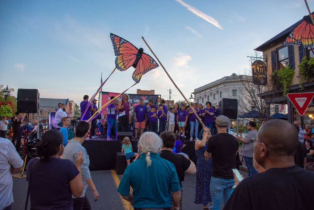 People gathering in front of a stage at Salsa on the Square