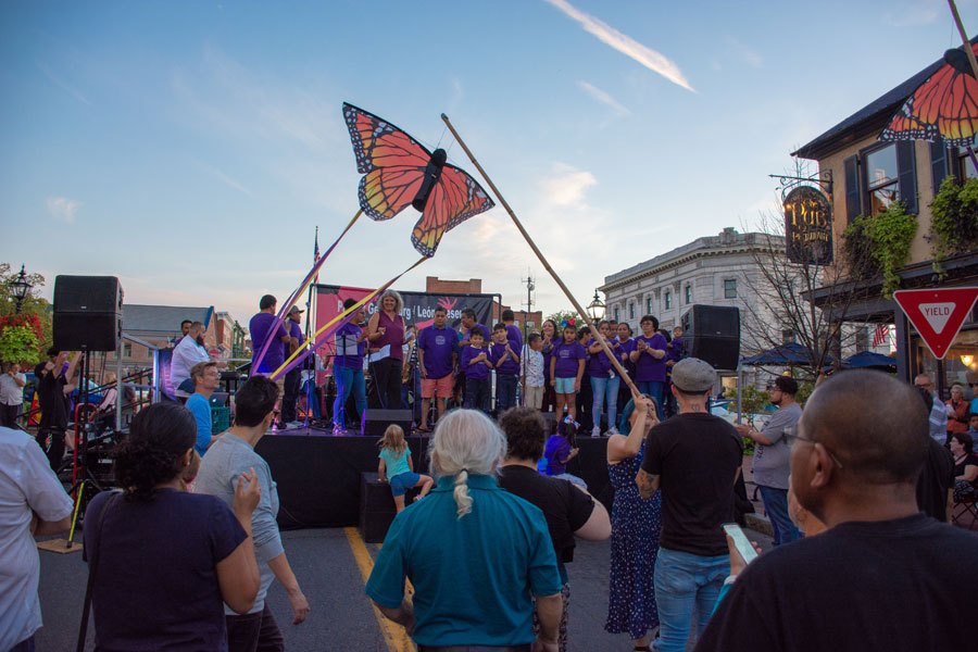 People gathered around a stage at Salsa on the Square