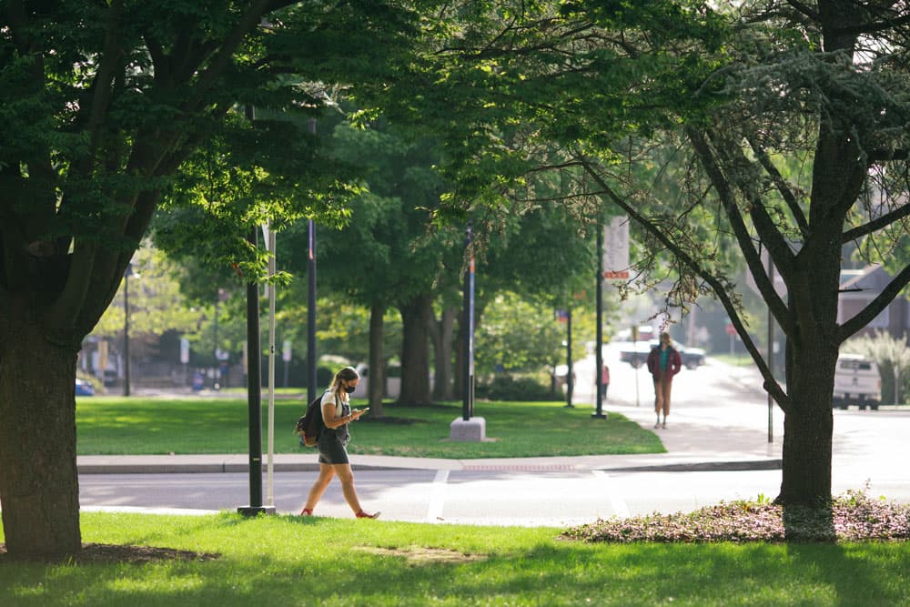 masked student on campus during first day of classes