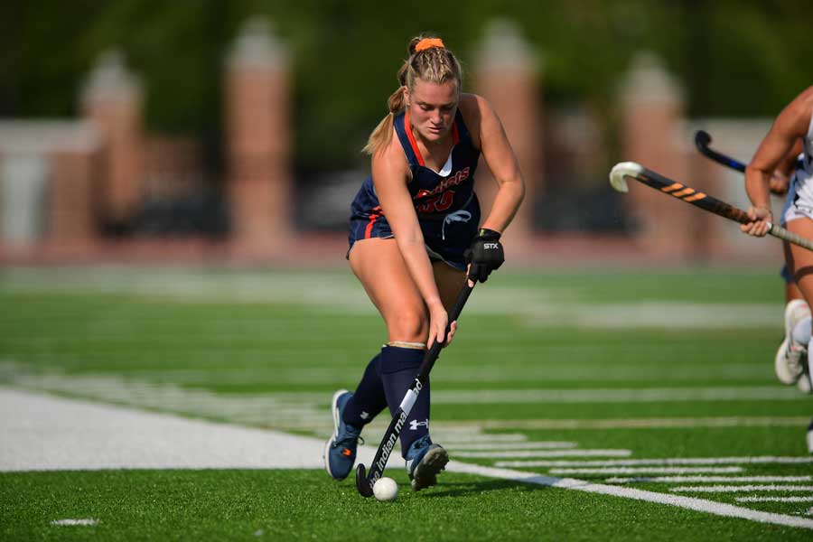 Charlotte Lacey playing Lacrosse on the field