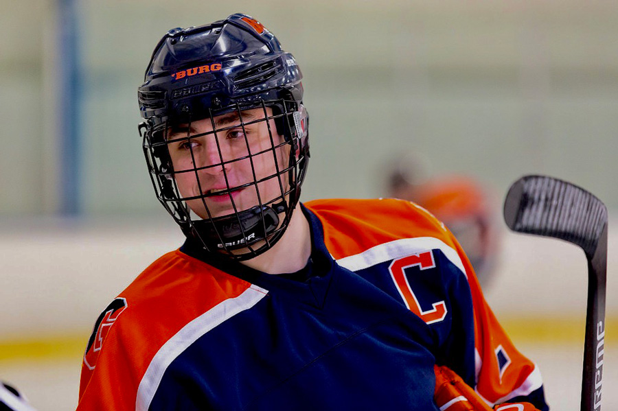 Colin Hetherington wearing an ice hockey helmet and the Gettysburg College team jersey