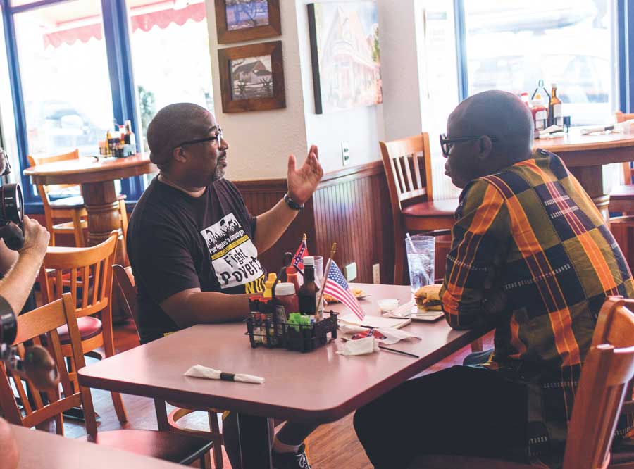 Darryl Jones and Bob the Drag Queen eating at the Blue and Gray Bar and Grill