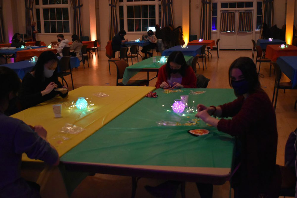 Students sitting in the ballroom making arts and crafts at the Diwali celebration