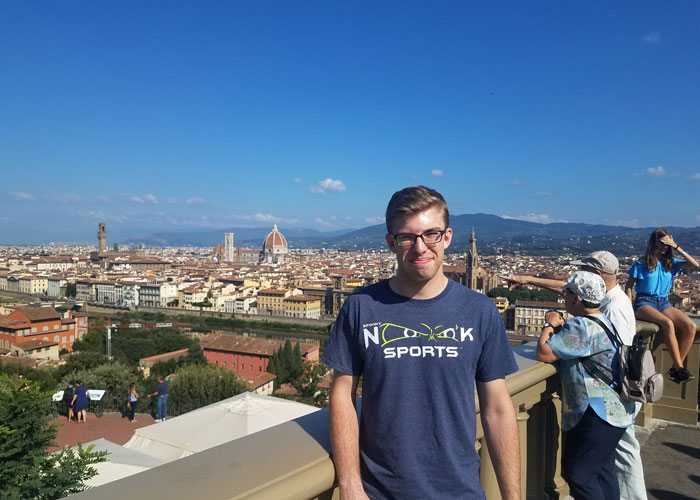Dylan O'Neil with an Italian city behind him