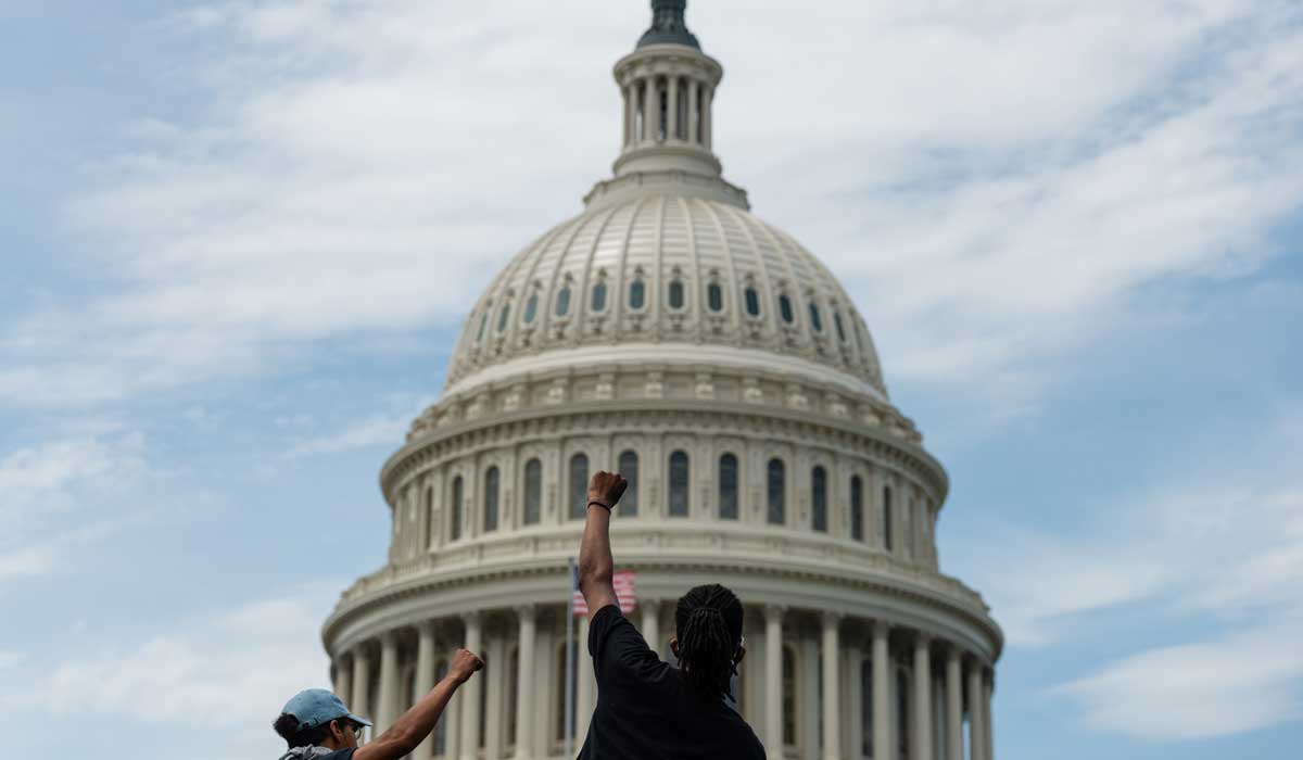 A man raises his fist in from of the US Capitol building in Washington DC