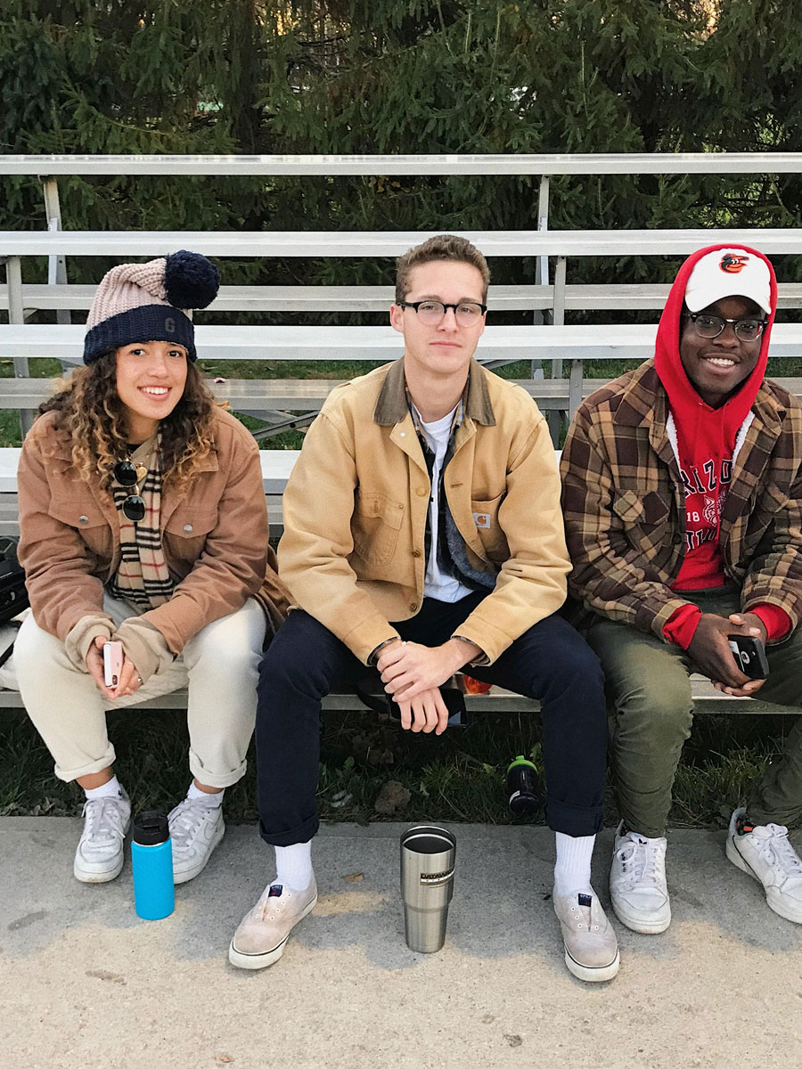 Flores sitting on bleachers with friends