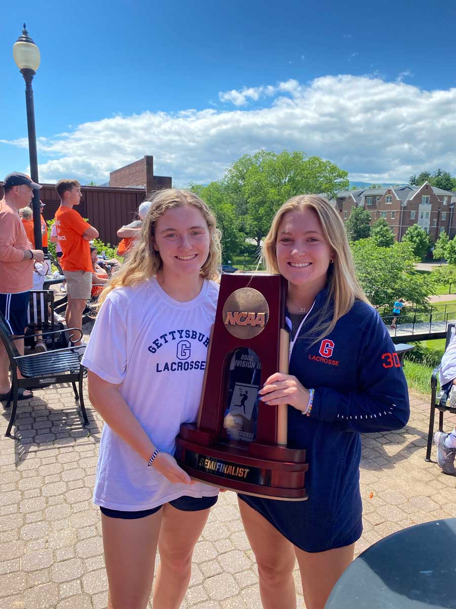 Greta and Charlotte Lacey holding a trophy
