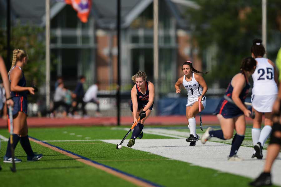 Greta Lacey playing Lacrosse