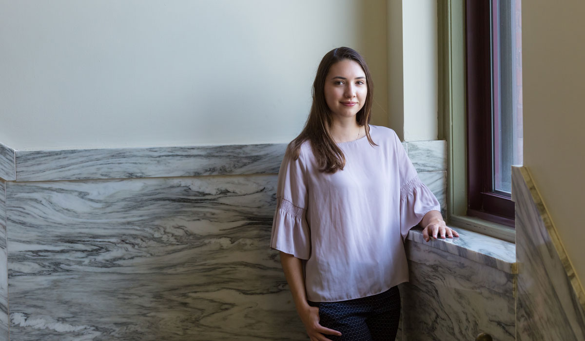 Haley Shultz standing in a hallway inside of Glatfelter Hall