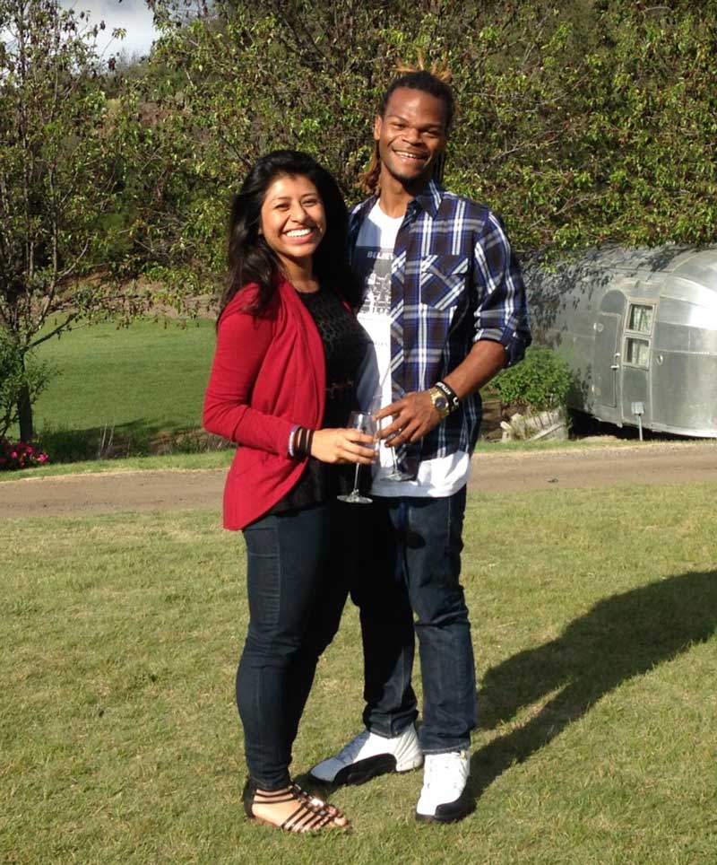 Johanna Hernandez and Malcolm Perry posing together outside