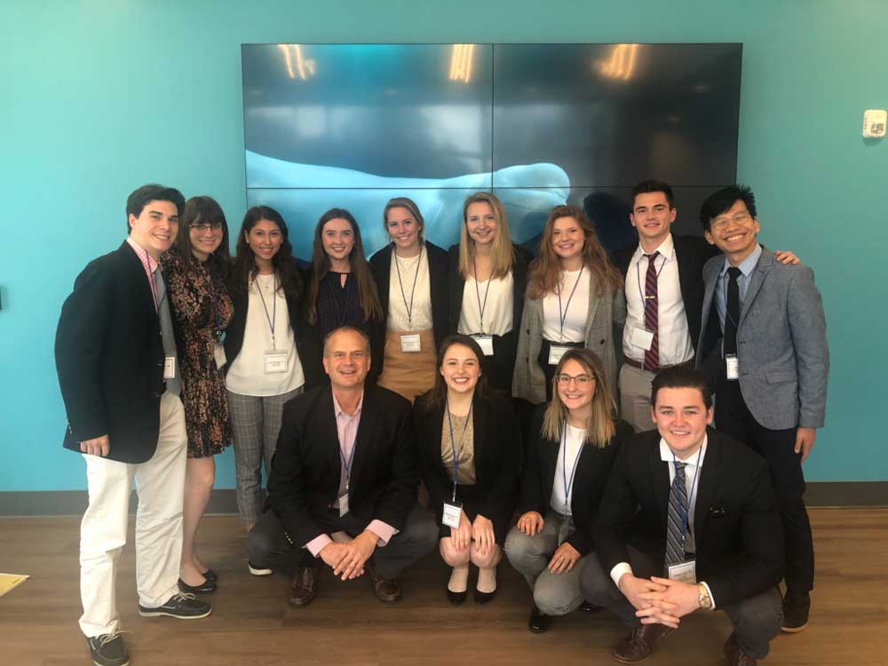 Students posing for a group photo in business attire