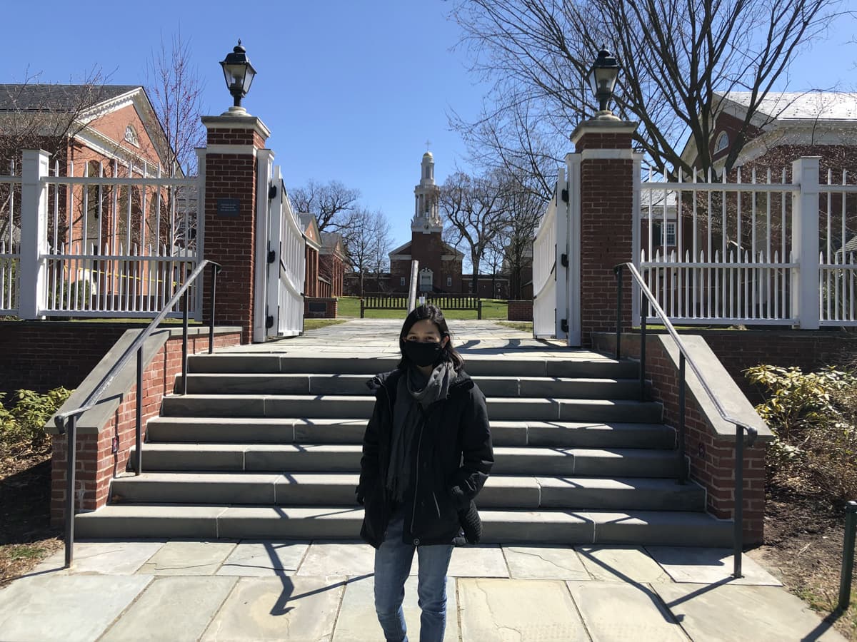 Julia Chin wears a mask in front of the Divinity School gate in winter