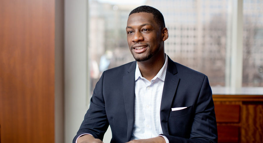 Julius Redd wearing a suit and sitting in an office setting