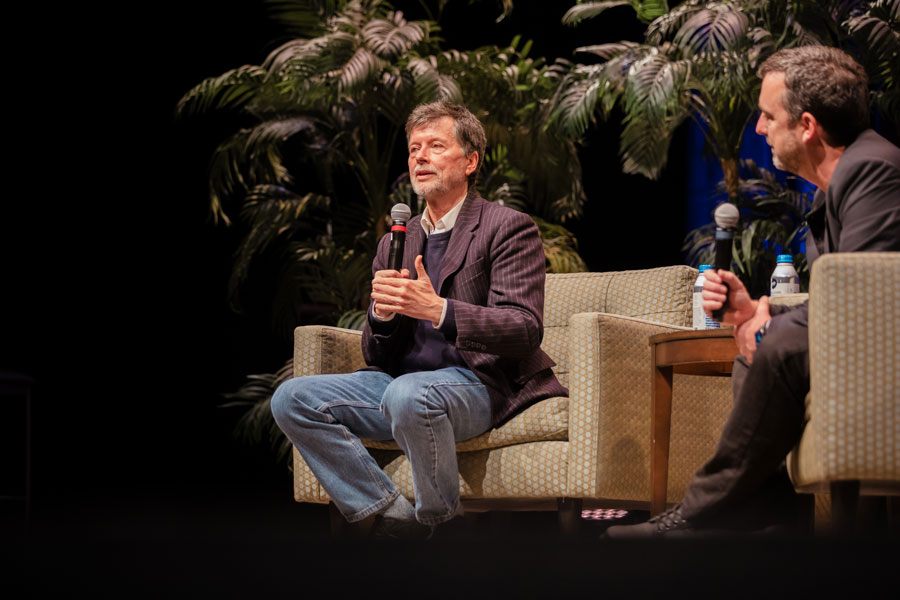 Ken Burns sitting down and speaking on stage