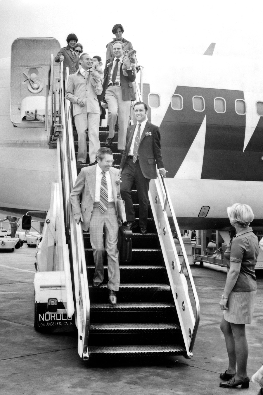 Chuck Bieler getting off of an airplane with Koala bears