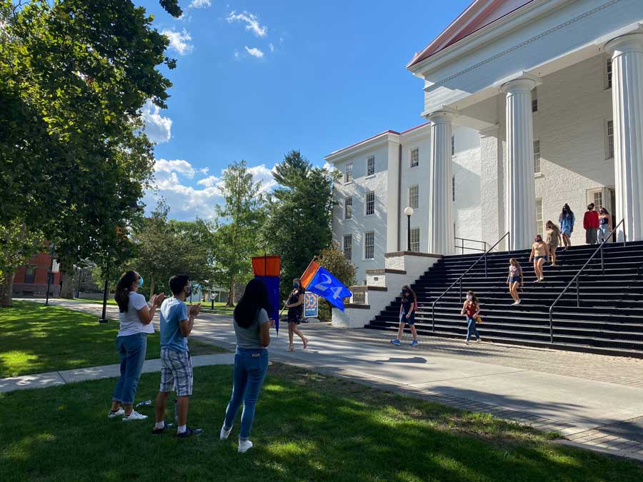 Students walking through Penn Hall in a matriculation ceremony