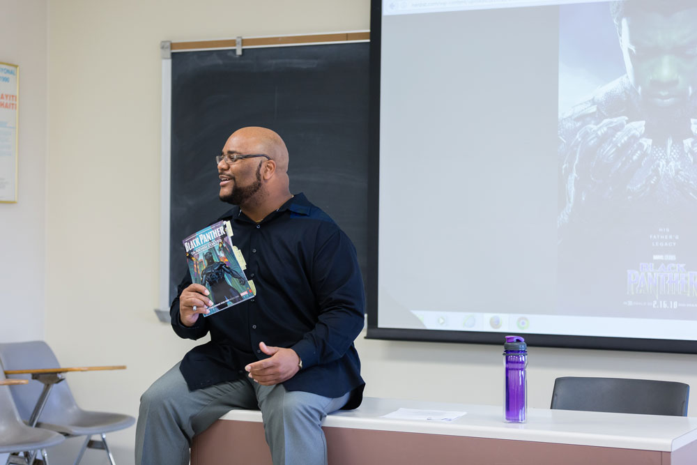 McKinley Melton holding a comic book in a classroom