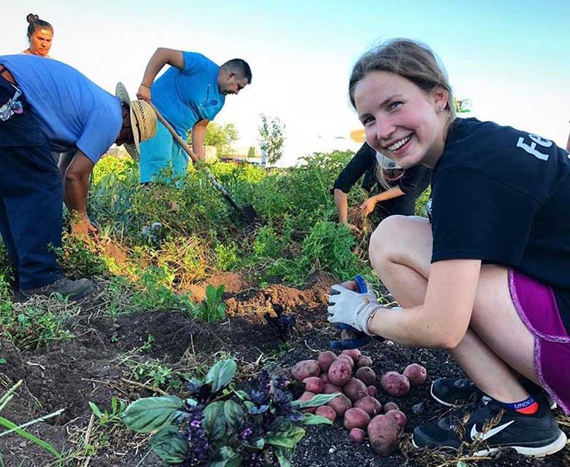 Katie Mercer working in a field on a farm