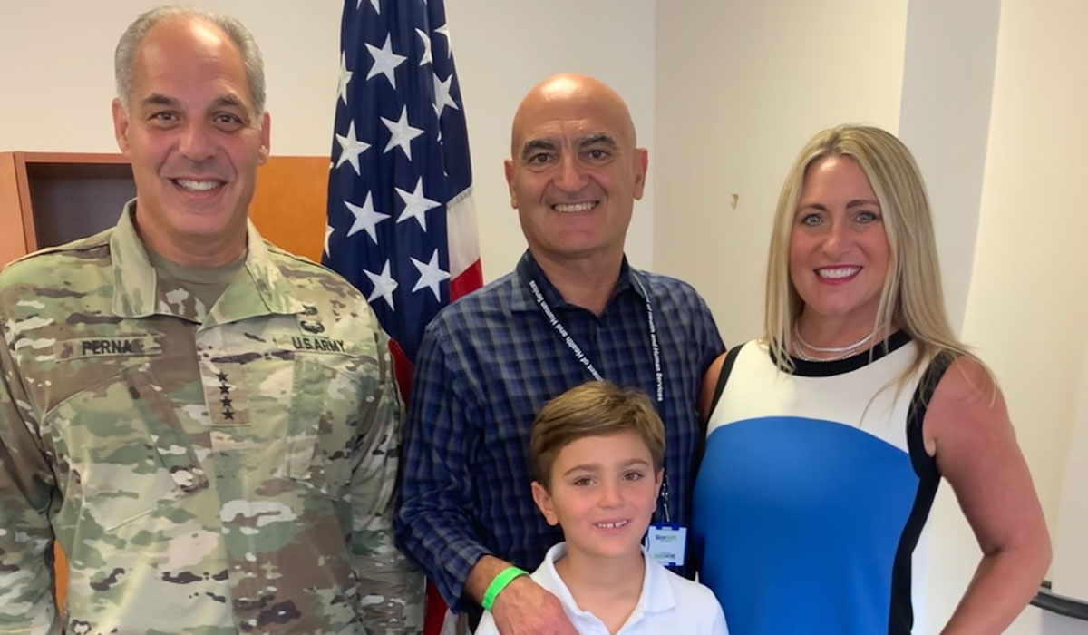 Doctor Moncef Slaoui posing for a photo with his family and General Gustave Perna