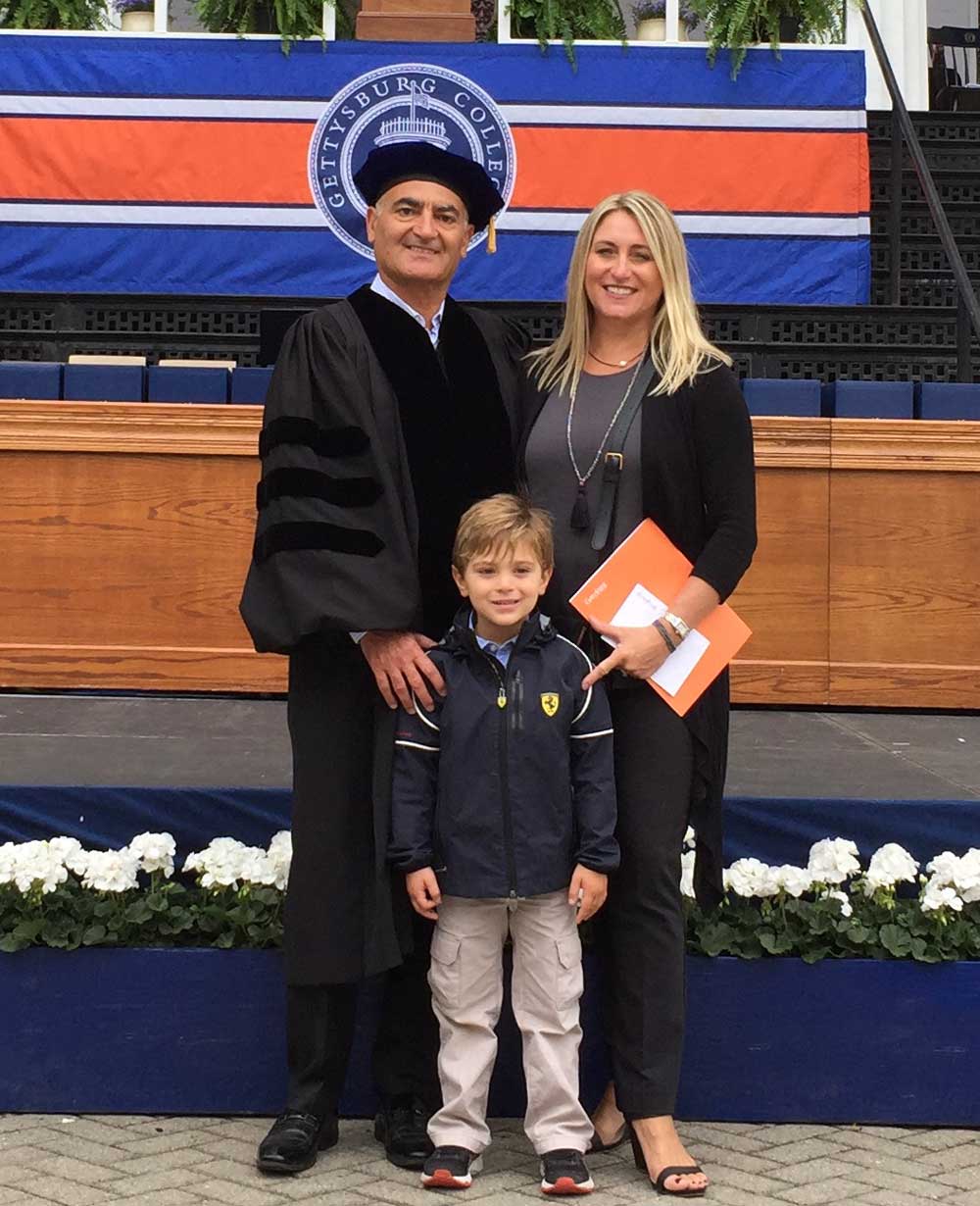 Doctor Moncef Slaoui posing with his wife and son at a Gettysburg College Commencement ceremony