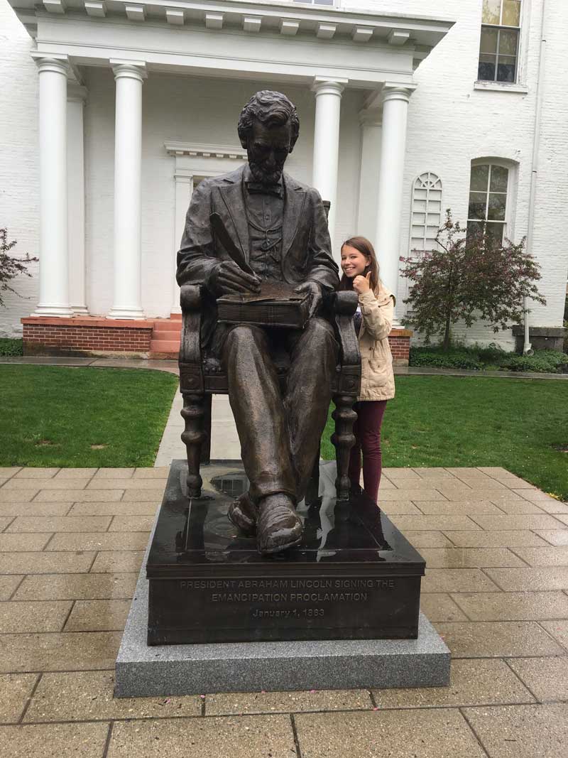 Julianna Pestretto standing next to a statue of Abraham Lincoln