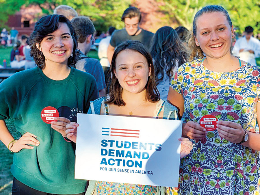 Phoebe Doscher '22 holding a poster promoting Students Demand Action for Gun Sense in America