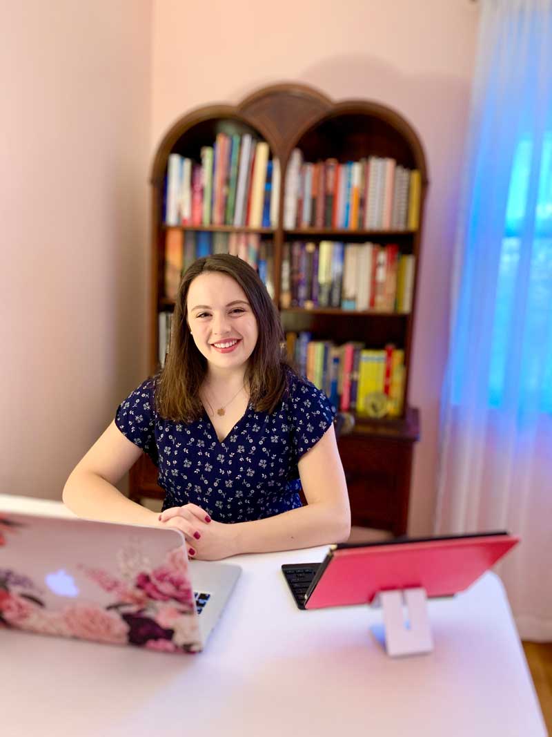 Phoebe Doscher sitting in her home office with a computer