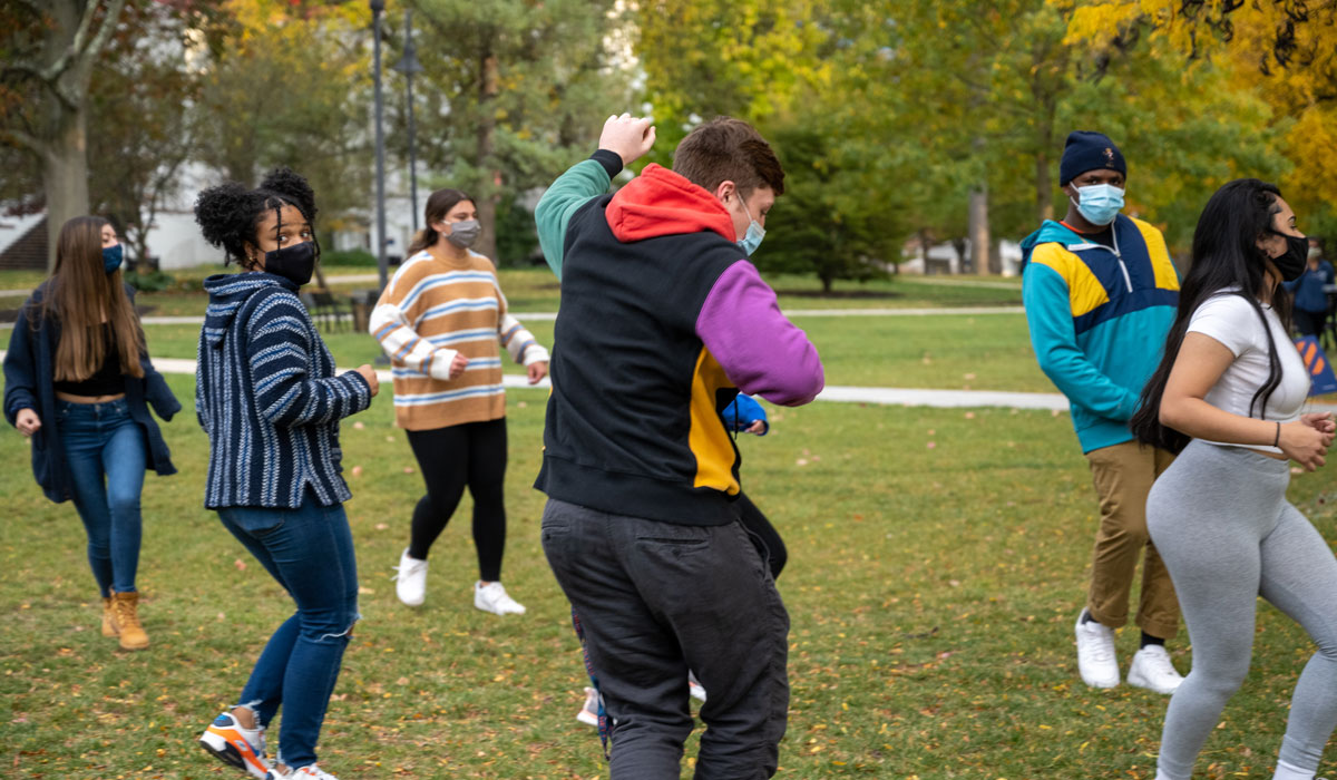 Students taking salsa lessons on Gettysburg College's campus during Salsa on the Square