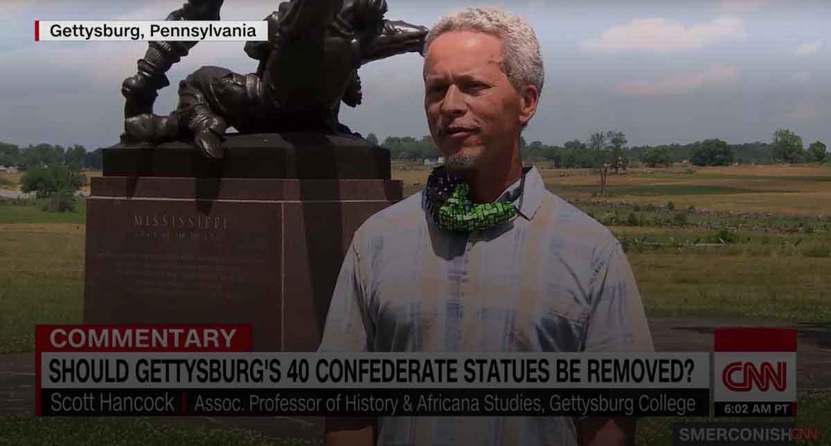 Professor Scott Hancock standing in front of a battlefield monument