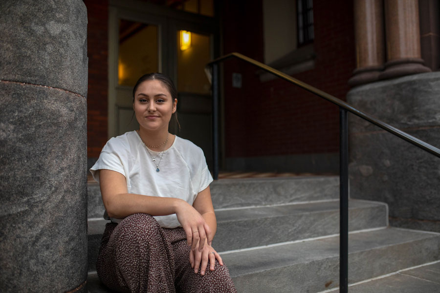 Sierra Conboy sitting on the steps of Glatfelter Hall