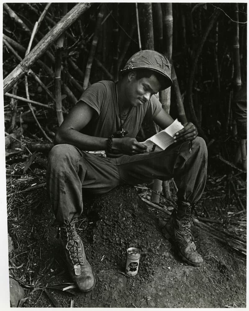 Soldier sitting and reading a letter