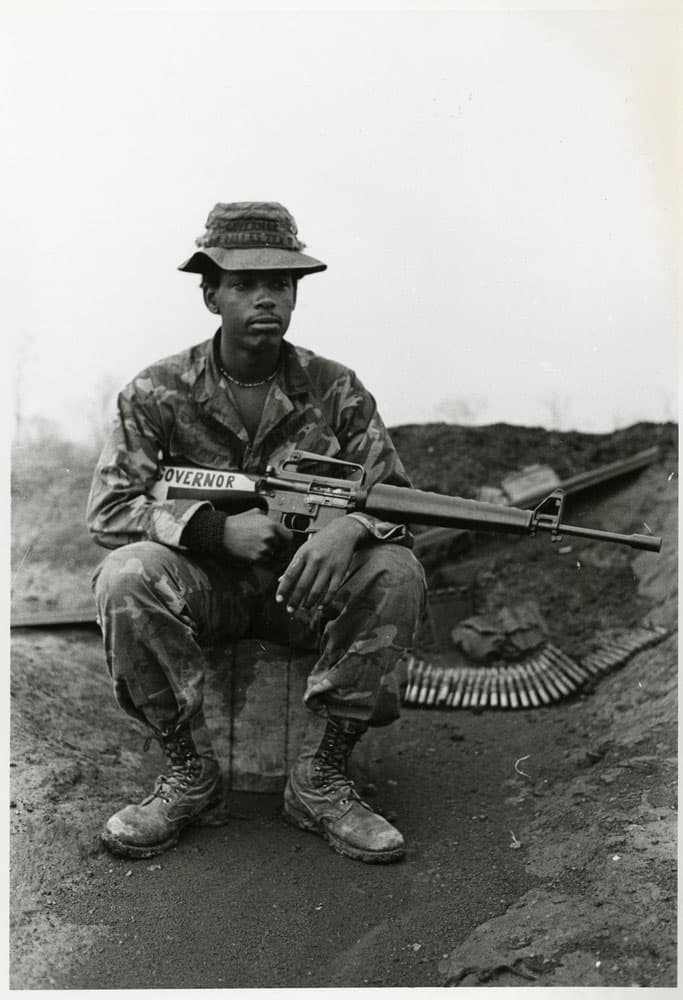 Soldier sitting with a rifle