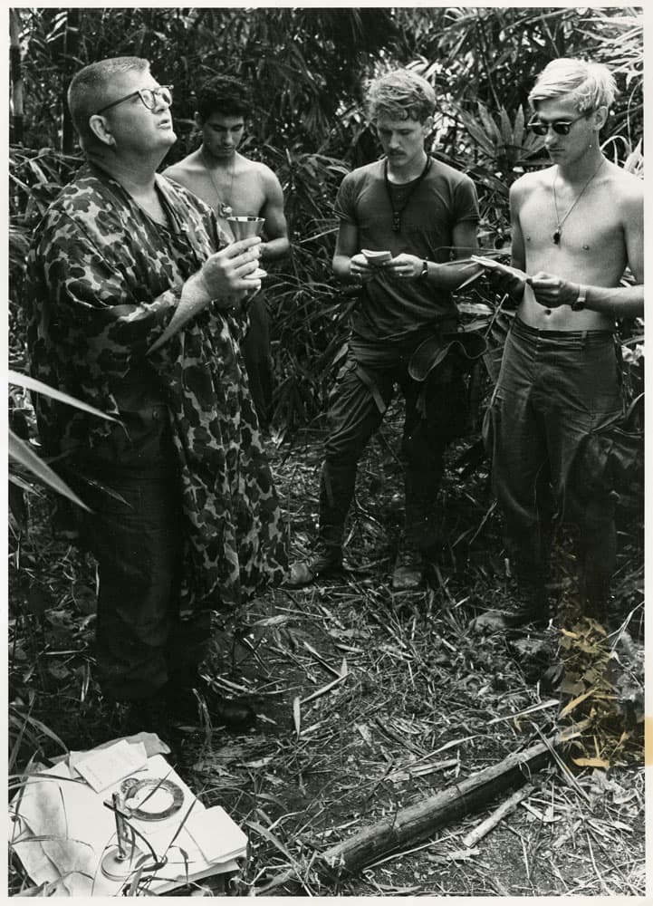 Soldiers standing in a circle saying prayers