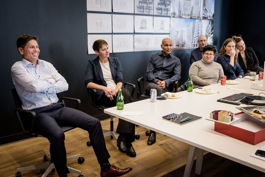 Employees sitting in a conference room at Steinberg Hart