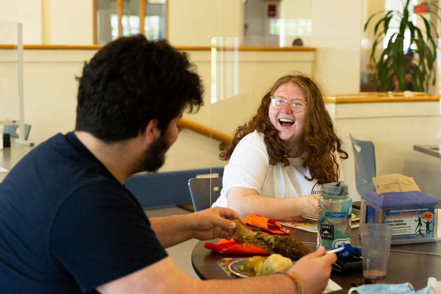 Two students chatting while eating their thanksgiving meal