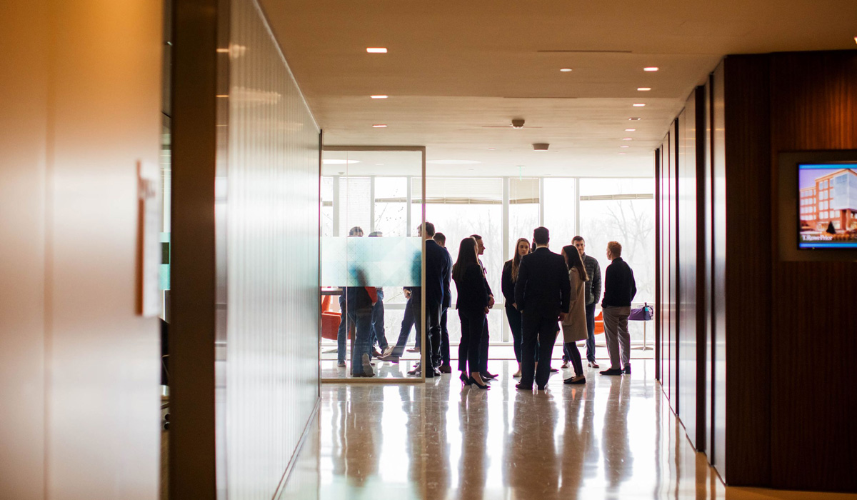 Students gathered inside of a T Rowe Price building