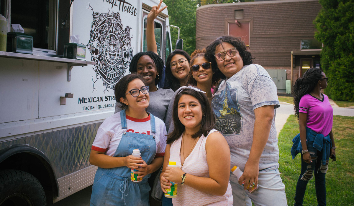 Hera Molina with a group of women standing next to a food truck