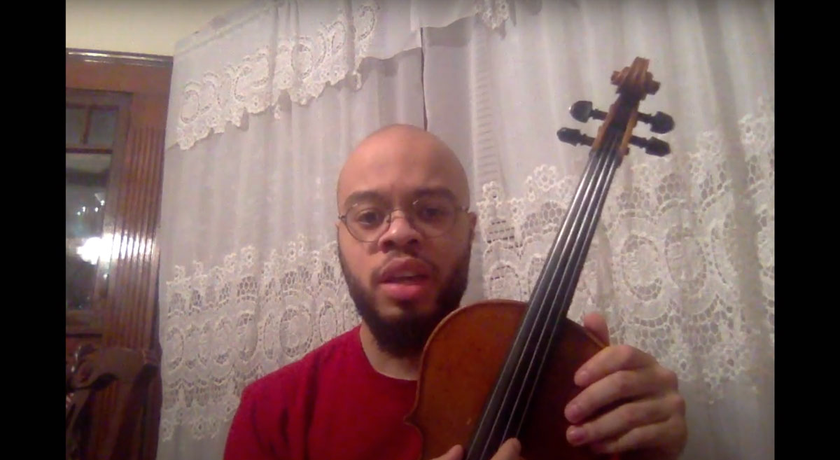 Sébastien Ridore ’19 holding a violin