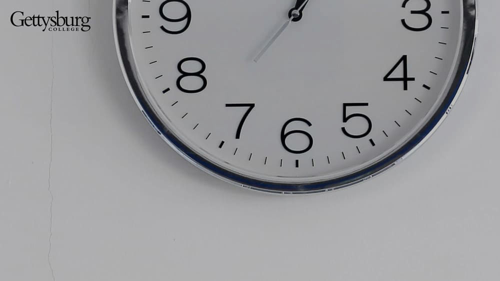 clock detail against a white wall - Gettysburg College