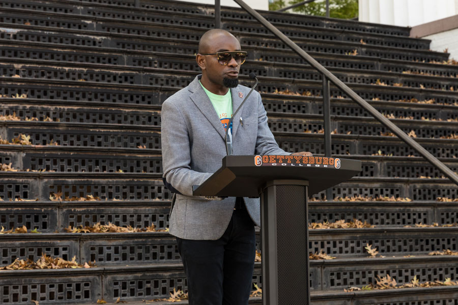 Professor Hakim Williams speaking at a podium