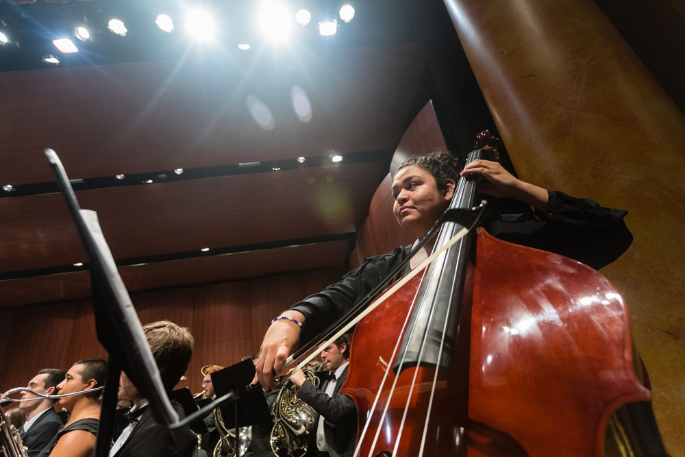 Hera Molina performing on stage with the Sunderman Conservatory wind symphony