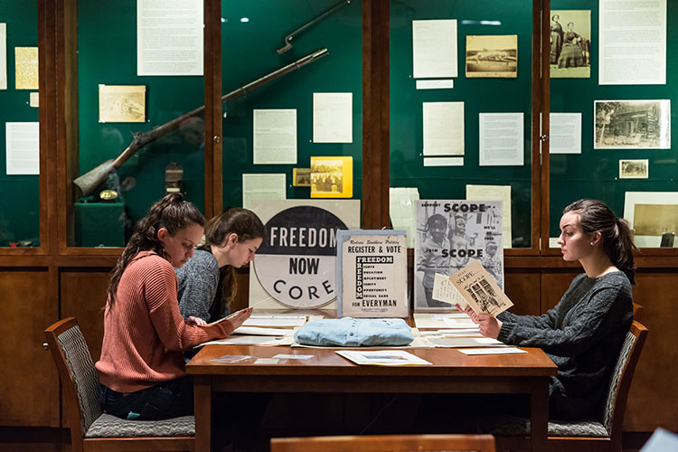Inside Civil Rights participants look through items collected by Richard Hutch ’67 