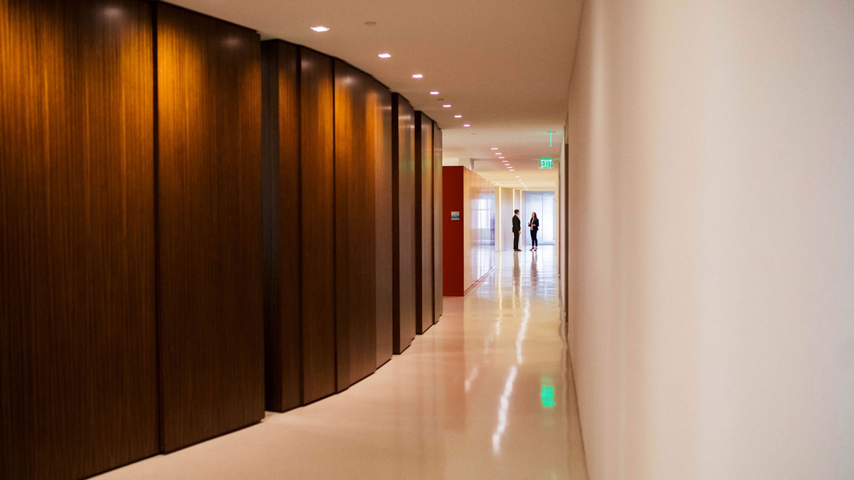 A hallway with two students standing and talking from afar