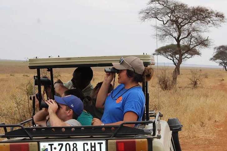 Venissa Ledesma 19 using a telescope on a car in Tanzania