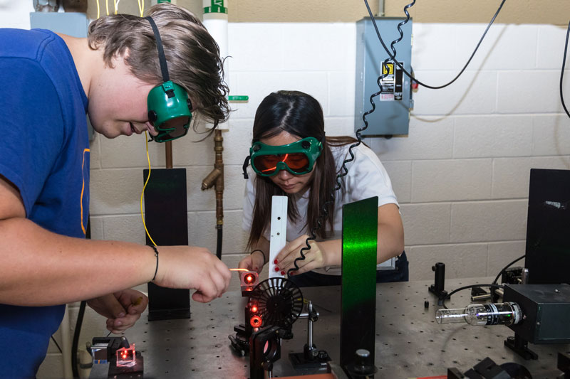 Students working on the Pickets Charged Plasma Device in a lab