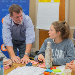 Faculty interacting with student.