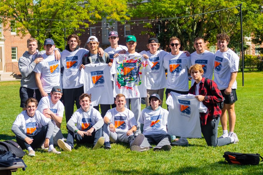 Students posing with Its On Us t-shirts