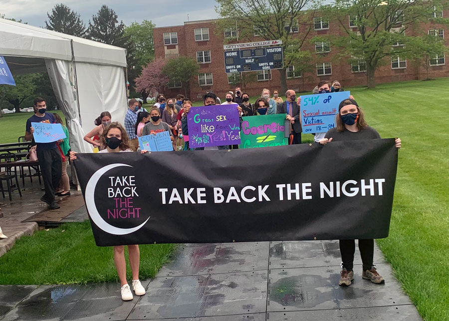 Take back the night student event with students holding posters